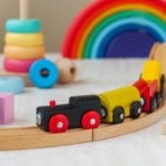 Wooden toys concept. Wooden toy railway and pyramid in the children room.